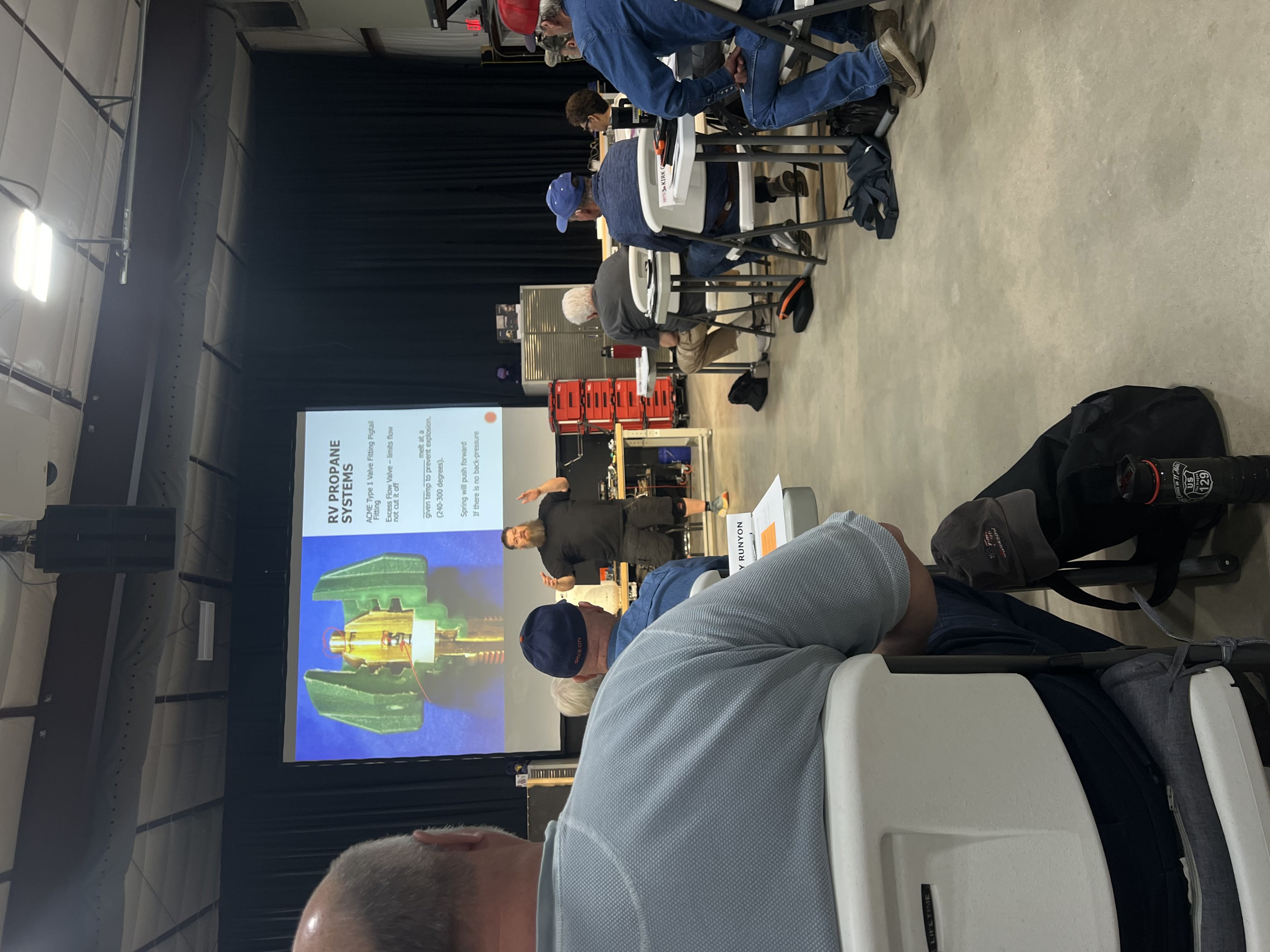 RV technician instructor presenting an RV Propane Systems lesson to a room of students at the NRVTA training facility